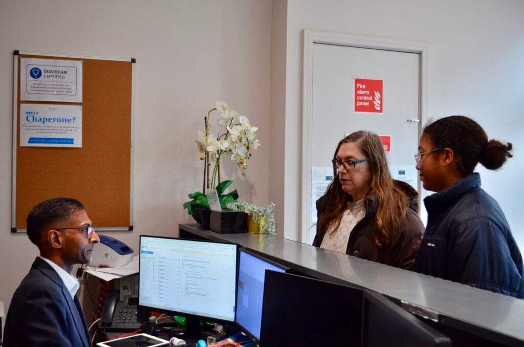 360 Med receptionist at front desk with computer