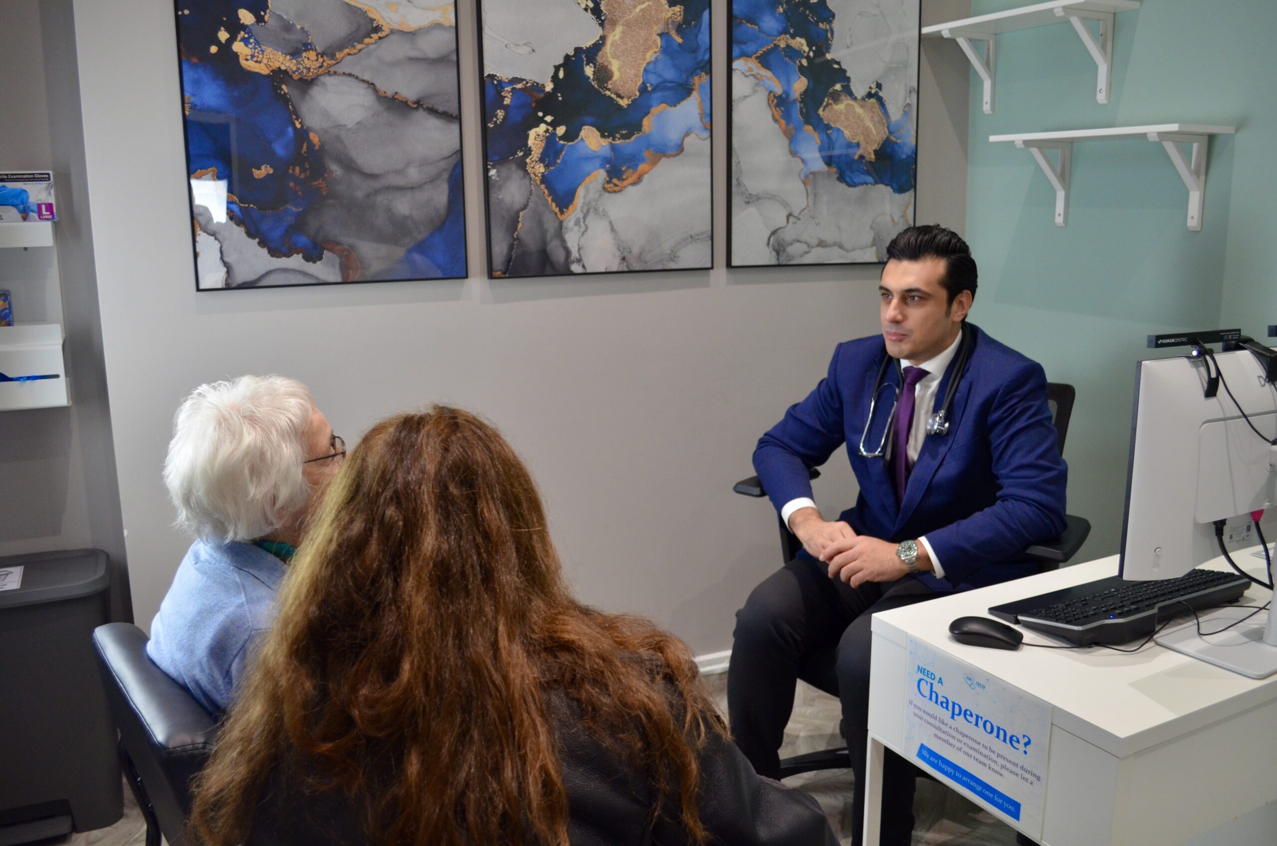 Doctor in suit consulting with patient in 360 Med office