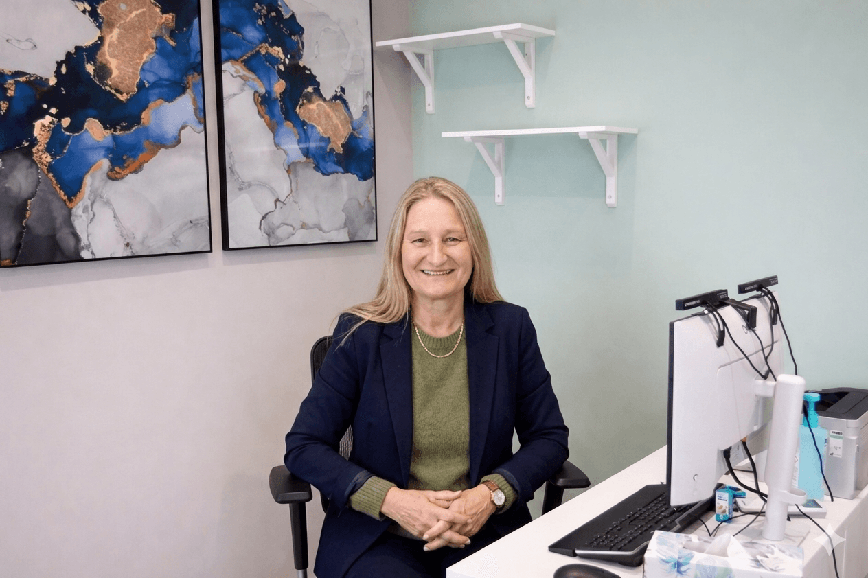 Lousie Miller Professional in blazer sitting during consultation at 360 Med